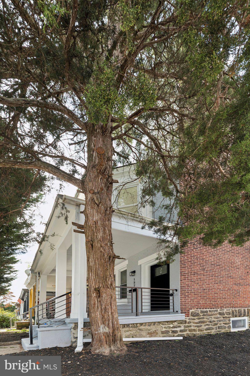 137 Manheim Street Philadelphia, PA 19144 - Photo 80 of 81 a front view of a house with a tree