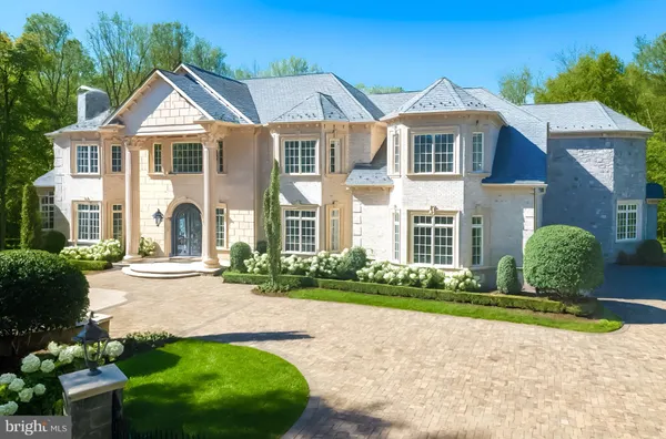 a front view of a house with a yard and outdoor seating