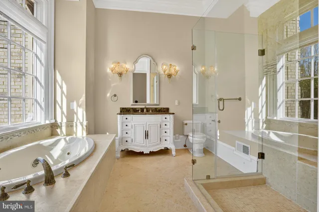 a bathroom with a tub sink and mirror