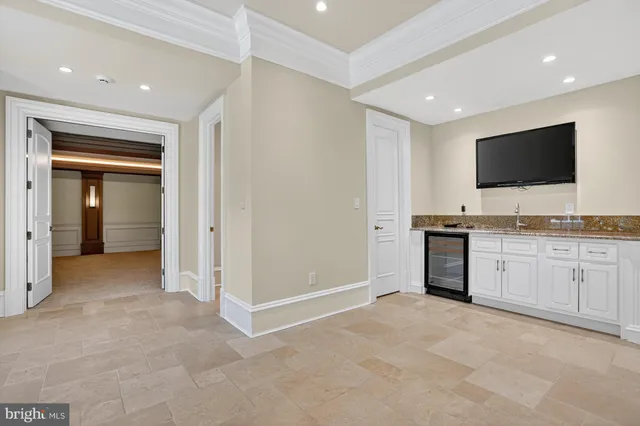 a large white kitchen with a sink and dishwasher stove top oven