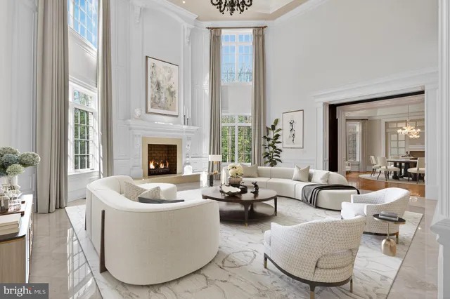 a living room with furniture fireplace and a large window