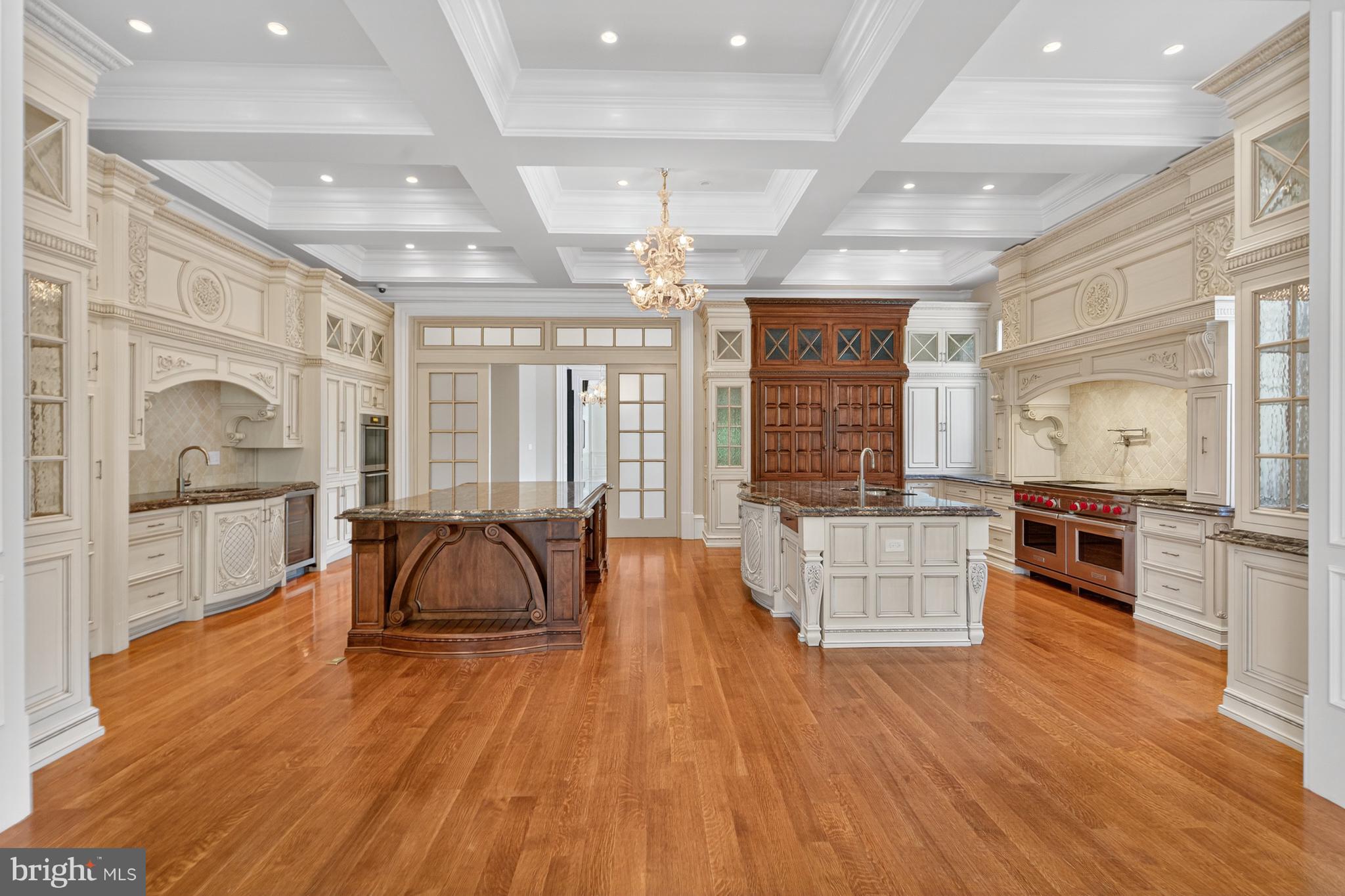 1174 Old Tolson Mill Road McLean, VA 22102 - Photo 10 of 35 a large room with kitchen island granite countertop wooden floors and wide window