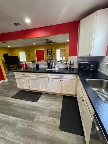 a kitchen with stainless steel appliances kitchen island granite countertop a sink and cabinets