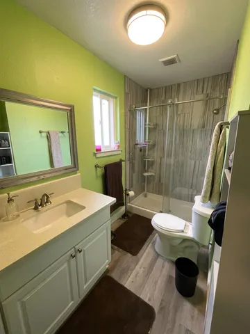 a bathroom with a sink mirror vanity and toilet