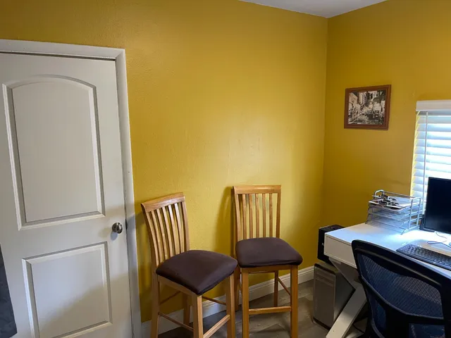 a view of a room with furniture and wooden floor