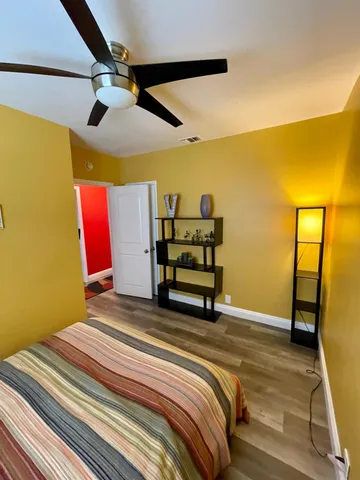 a bedroom with a bed and wooden floor