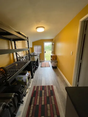 a very nice looking room with wooden floor and furniture