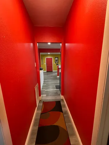 a view of a balcony with wooden floor and a wall