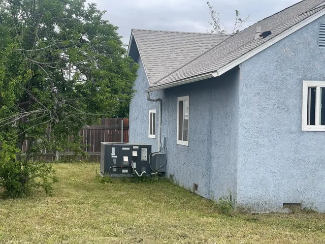a backyard of a house with barbeque oven