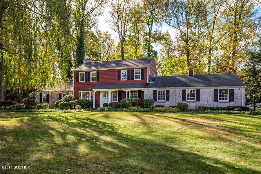 65 Winthrop Drive Riverside, CT 06878 - Photo 1 of 13 a view of a big yard next to a house with a big yard and large trees