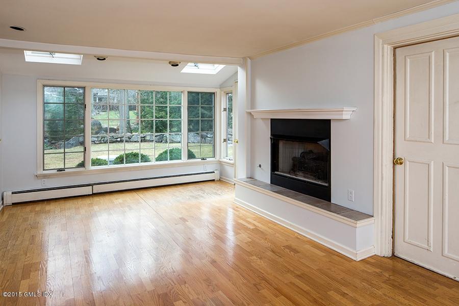 65 Winthrop Drive Riverside, CT 06878 - Photo 2 of 13 a view of dining room with wooden floor and fireplace