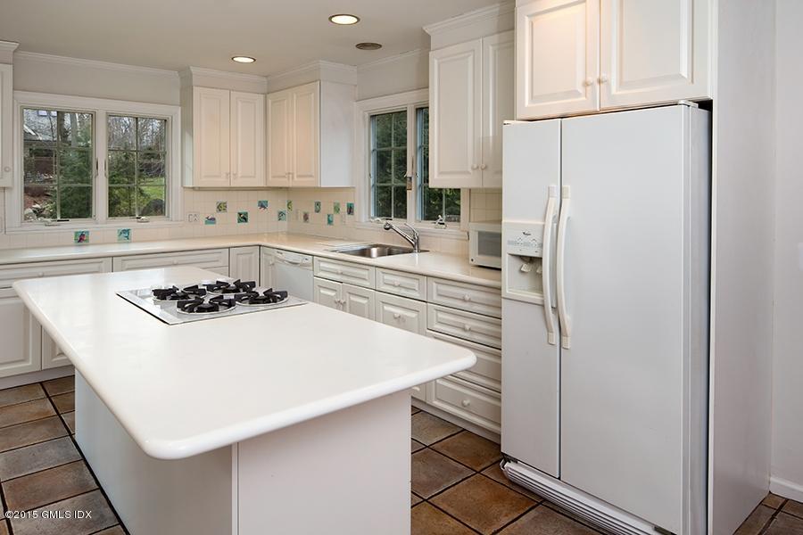 65 Winthrop Drive Riverside, CT 06878 - Photo 3 of 13 a kitchen with a sink a stove and white cabinets
