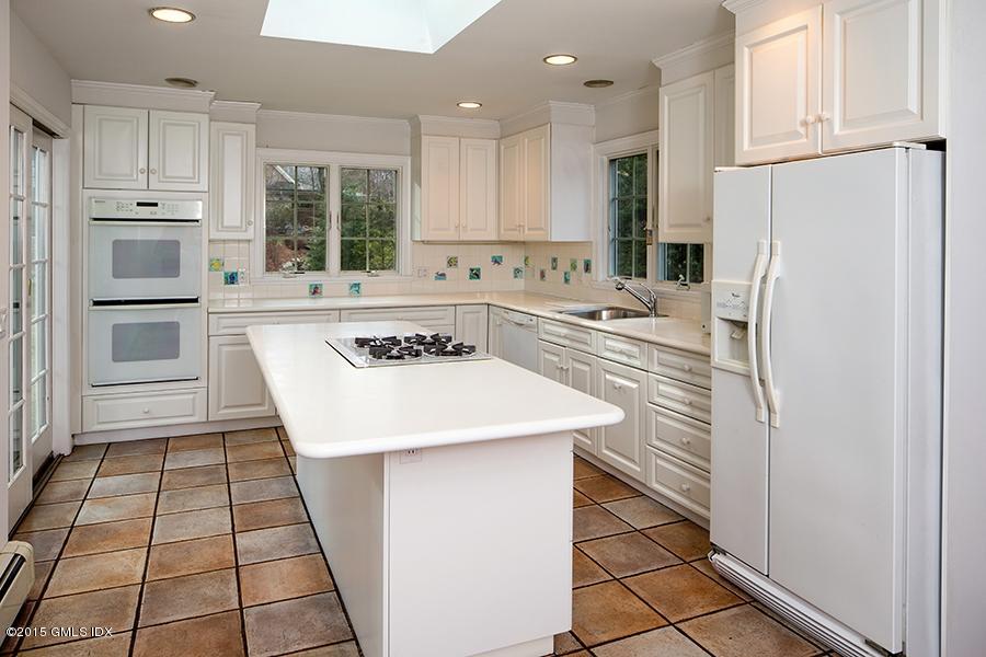 65 Winthrop Drive Riverside, CT 06878 - Photo 4 of 13 a kitchen with a sink a stove a refrigerator and cabinets