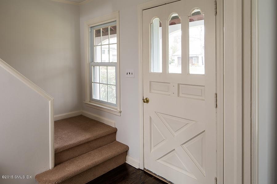 65 Winthrop Drive Riverside, CT 06878 - Photo 7 of 13 a hallway with sliding door and chandelier