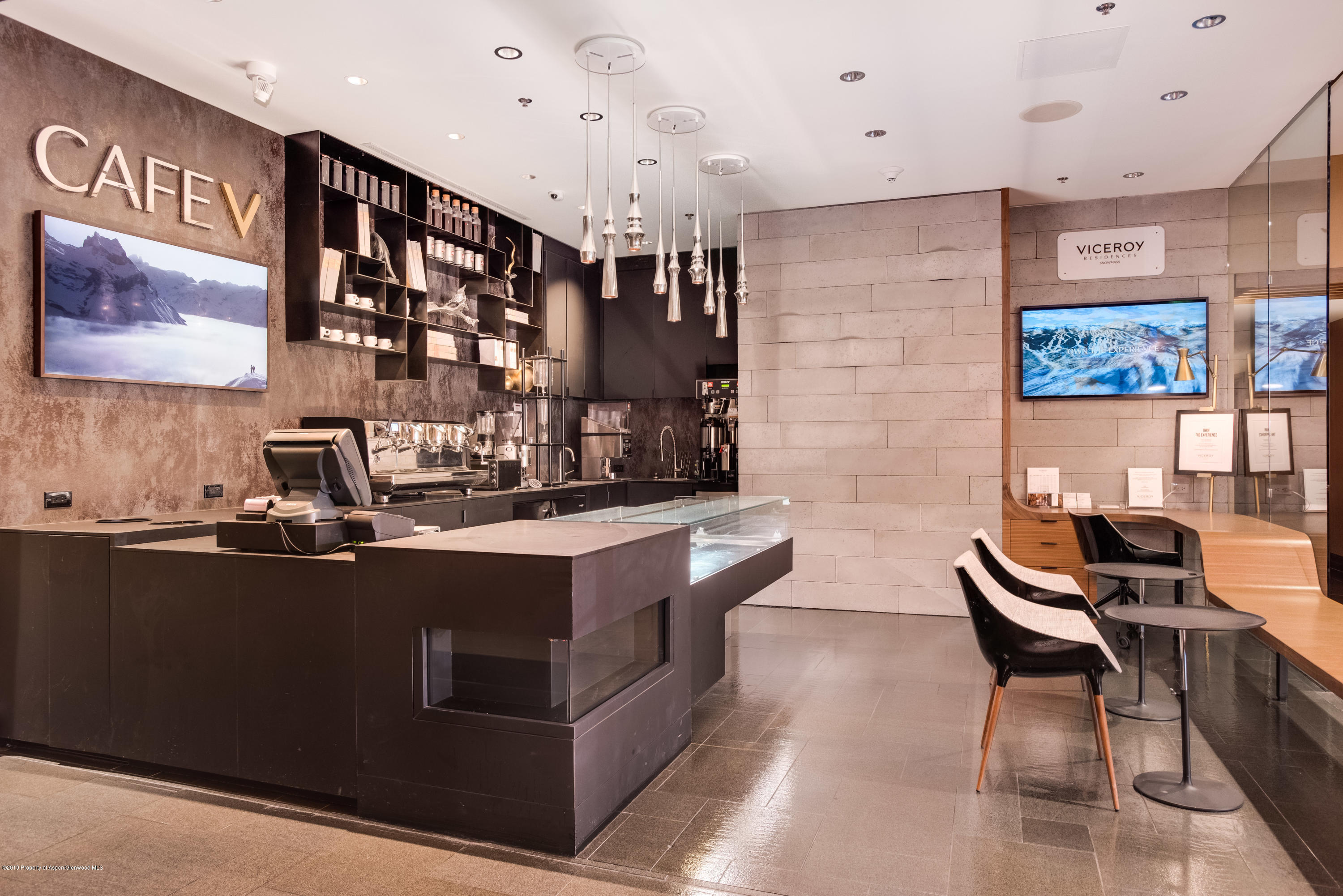 130 Wood Road, Unit 736 Snowmass Village, CO 81615 - Photo 1 of 12 a kitchen with stainless steel appliances kitchen island granite countertop a sink and cabinets