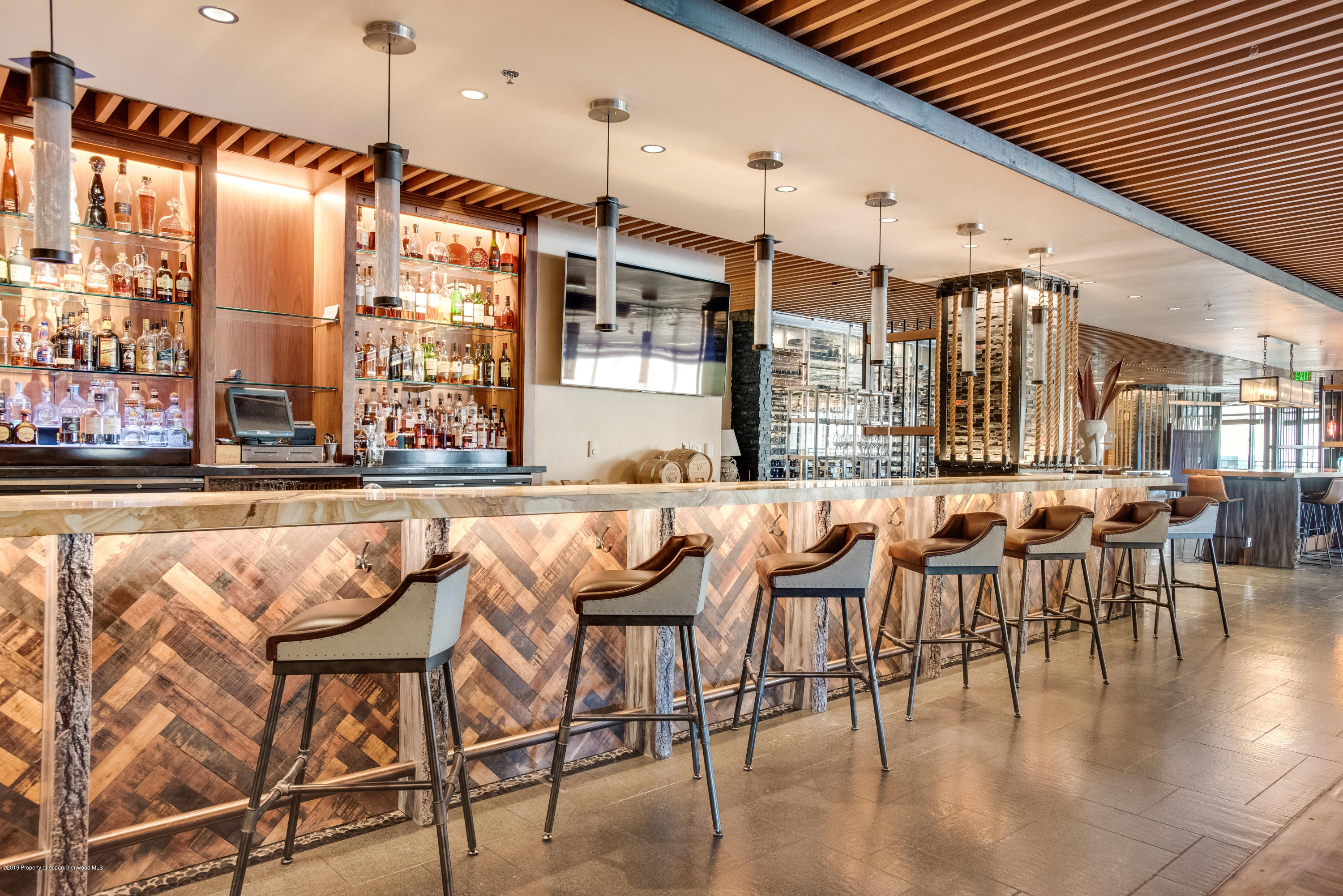 130 Wood Road, Unit 736 Snowmass Village, CO 81615 - Photo 2 of 12 a dining hall with stainless steel appliances granite countertop a table chairs and a view of living room