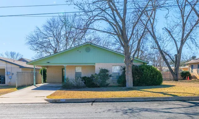 a house that has a tree in front of it