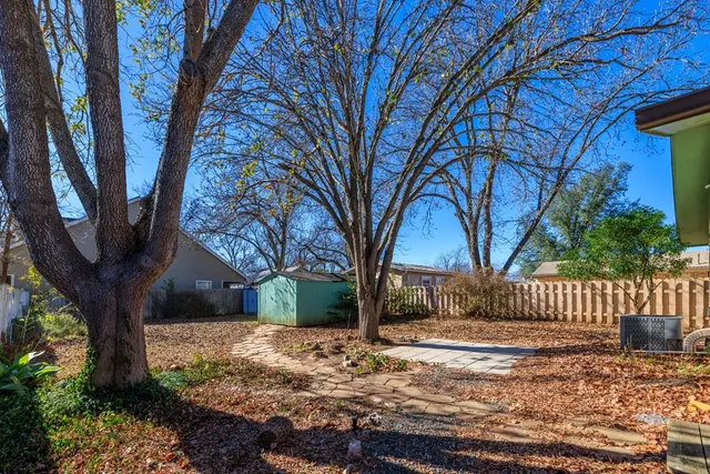 a view of house with yard and tree