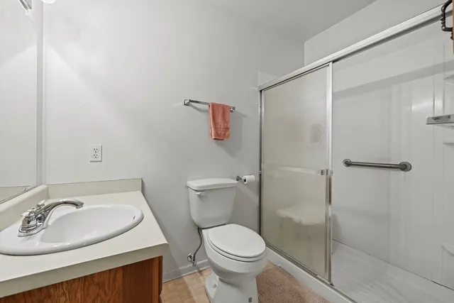 a bathroom with a sink toilet and shower