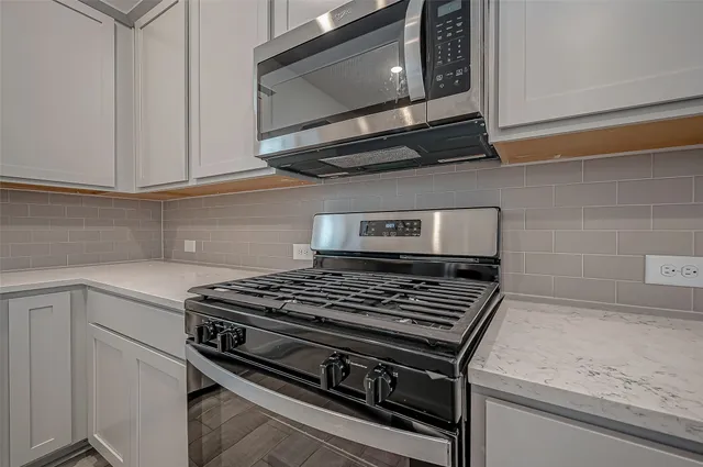 a stove top oven sitting inside of a kitchen