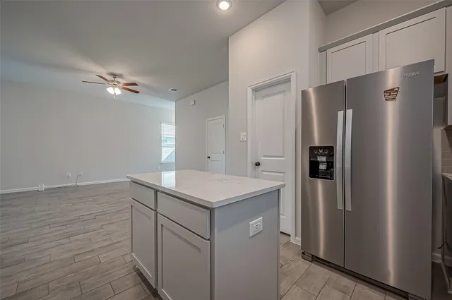 a kitchen with a refrigerator and a sink