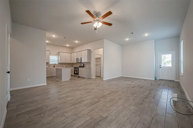 a view of kitchen with cabinets and wooden floor