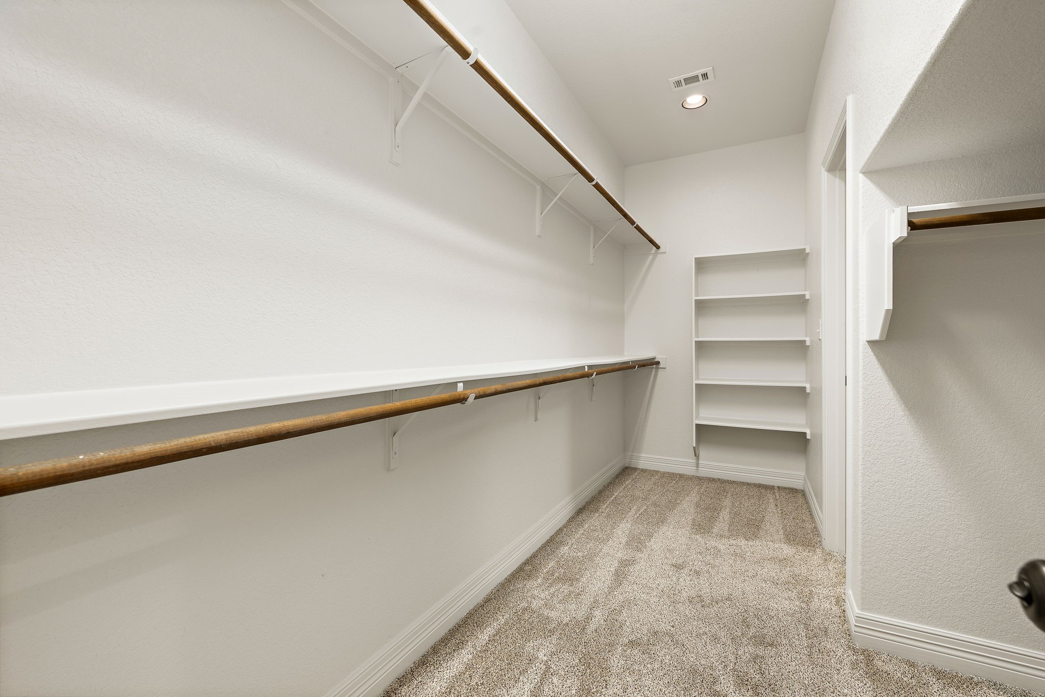 2137 Ringstaff Road Leander, TX 78641 - Photo 23 of 40 This second primary suite closet opens up to the laundry room.
