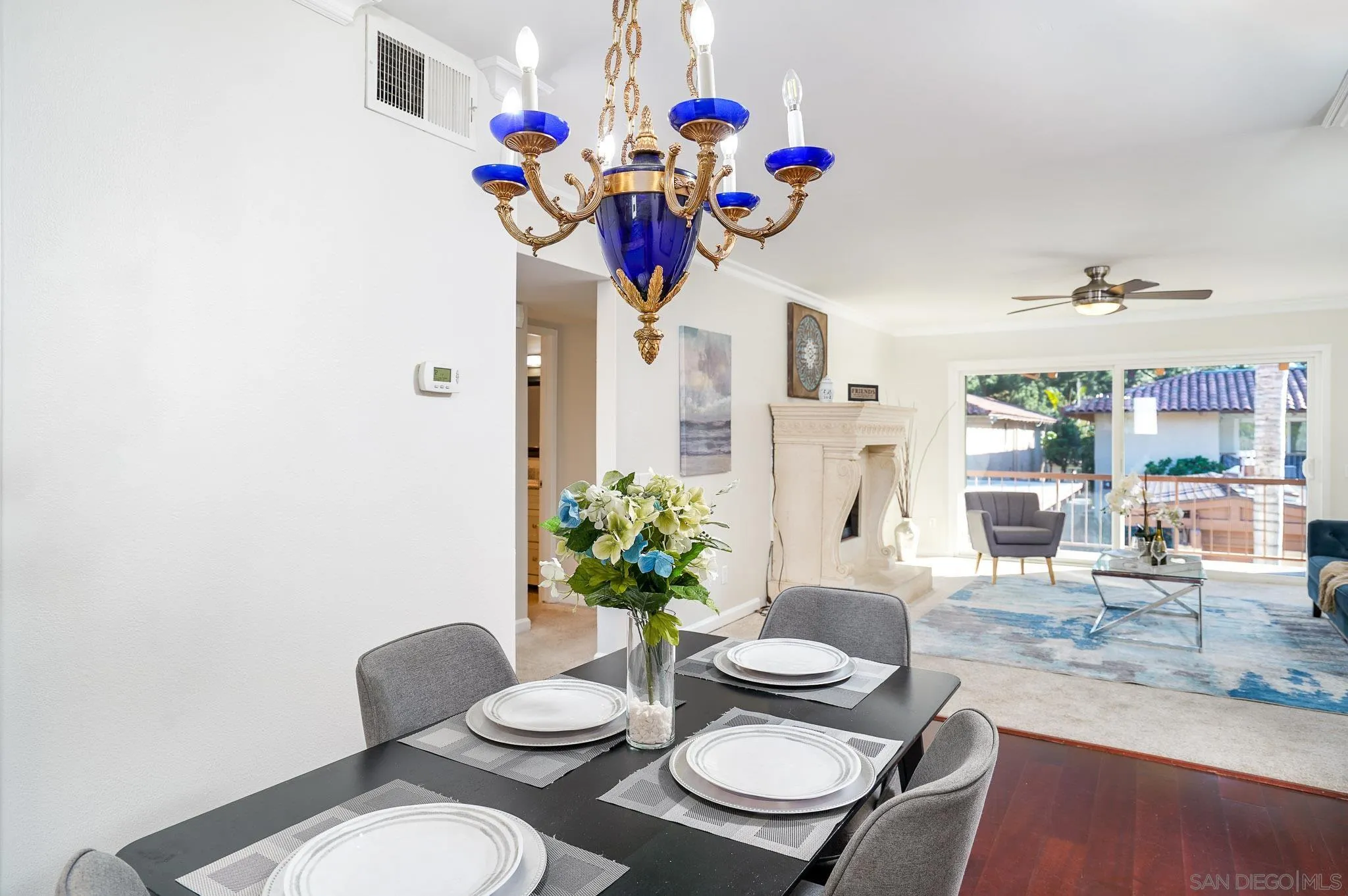 6069 Rancho Mission Road, Unit 201 San Diego, CA 92108 - Photo 11 of 43 a view of a dining room with furniture a potted plant and wooden floor