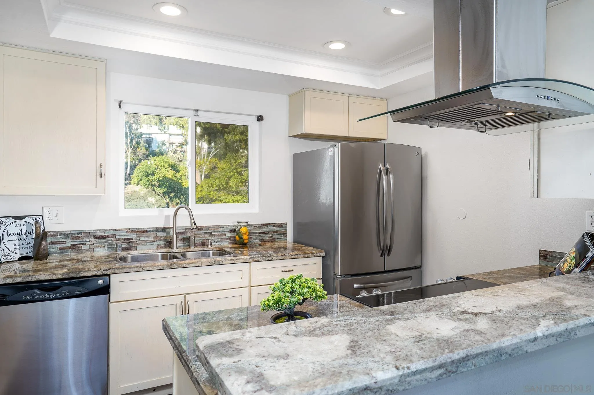 6069 Rancho Mission Road, Unit 201 San Diego, CA 92108 - Photo 12 of 43 a kitchen with stainless steel appliances granite countertop a sink refrigerator and cabinets