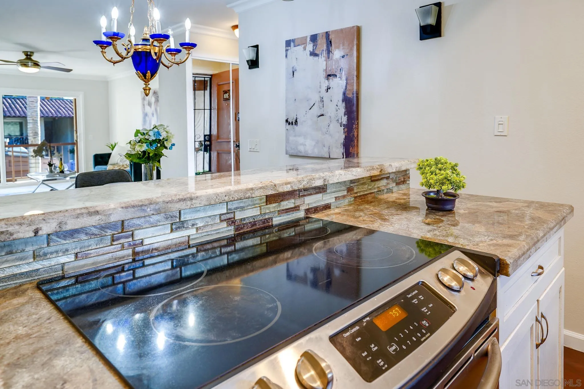 6069 Rancho Mission Road, Unit 201 San Diego, CA 92108 - Photo 14 of 43 a view of a kitchen counter top space with furniture and flower pot