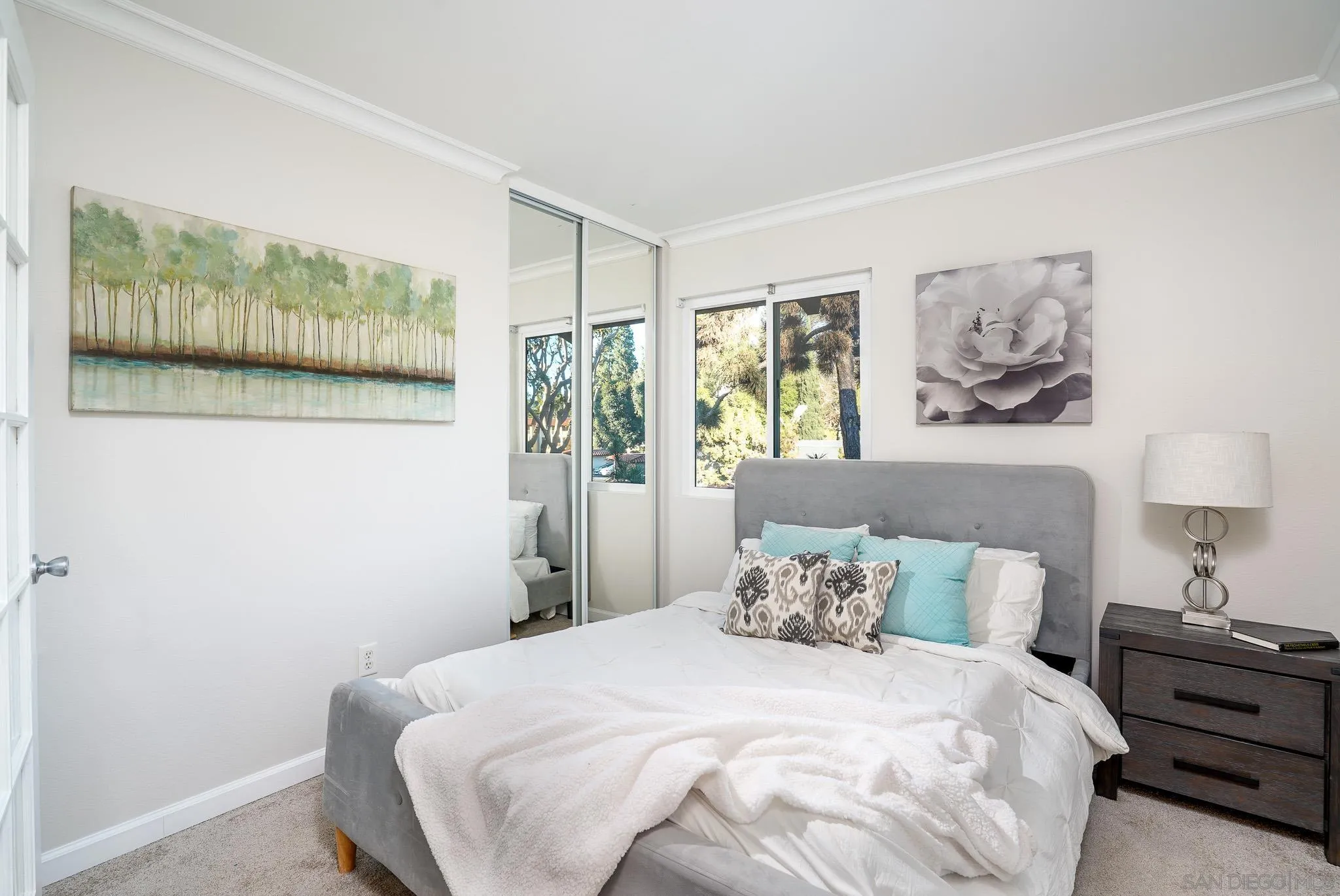 6069 Rancho Mission Road, Unit 201 San Diego, CA 92108 - Photo 17 of 43 a bedroom with a bed and a painting on the wall
