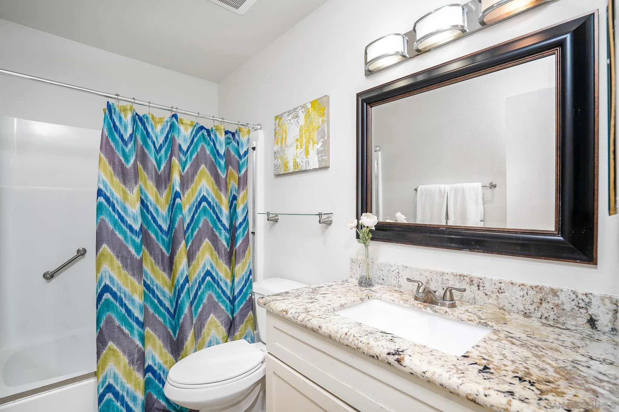 6069 Rancho Mission Road, Unit 201 San Diego, CA 92108 - Photo 20 of 43 a bathroom with a granite countertop toilet sink and mirror