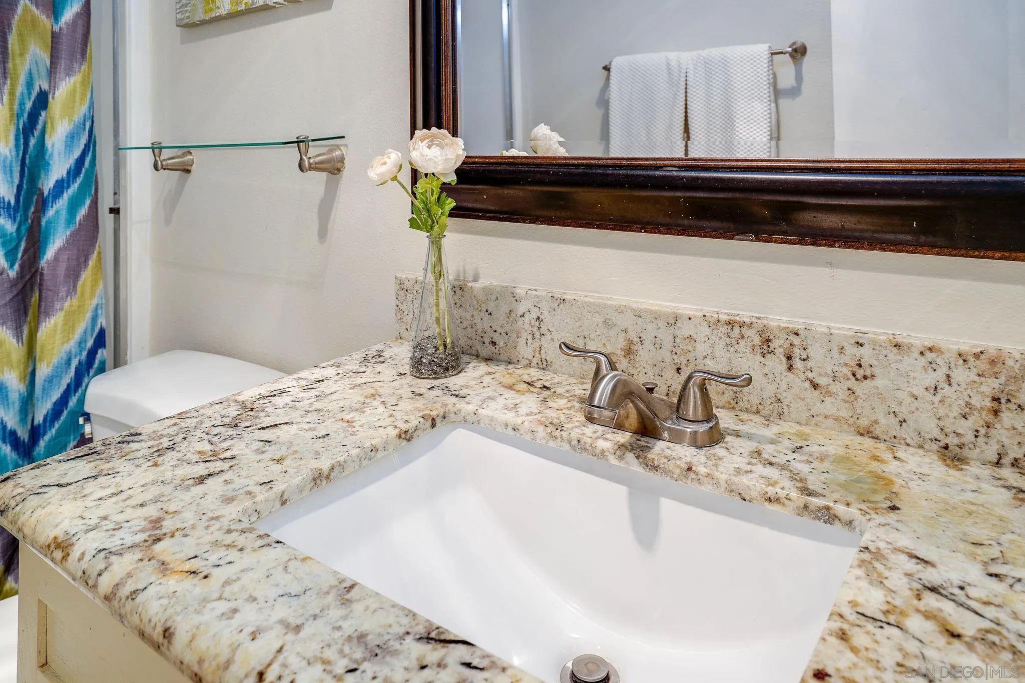 6069 Rancho Mission Road, Unit 201 San Diego, CA 92108 - Photo 22 of 43 a bathroom with a granite countertop sink and a mirror