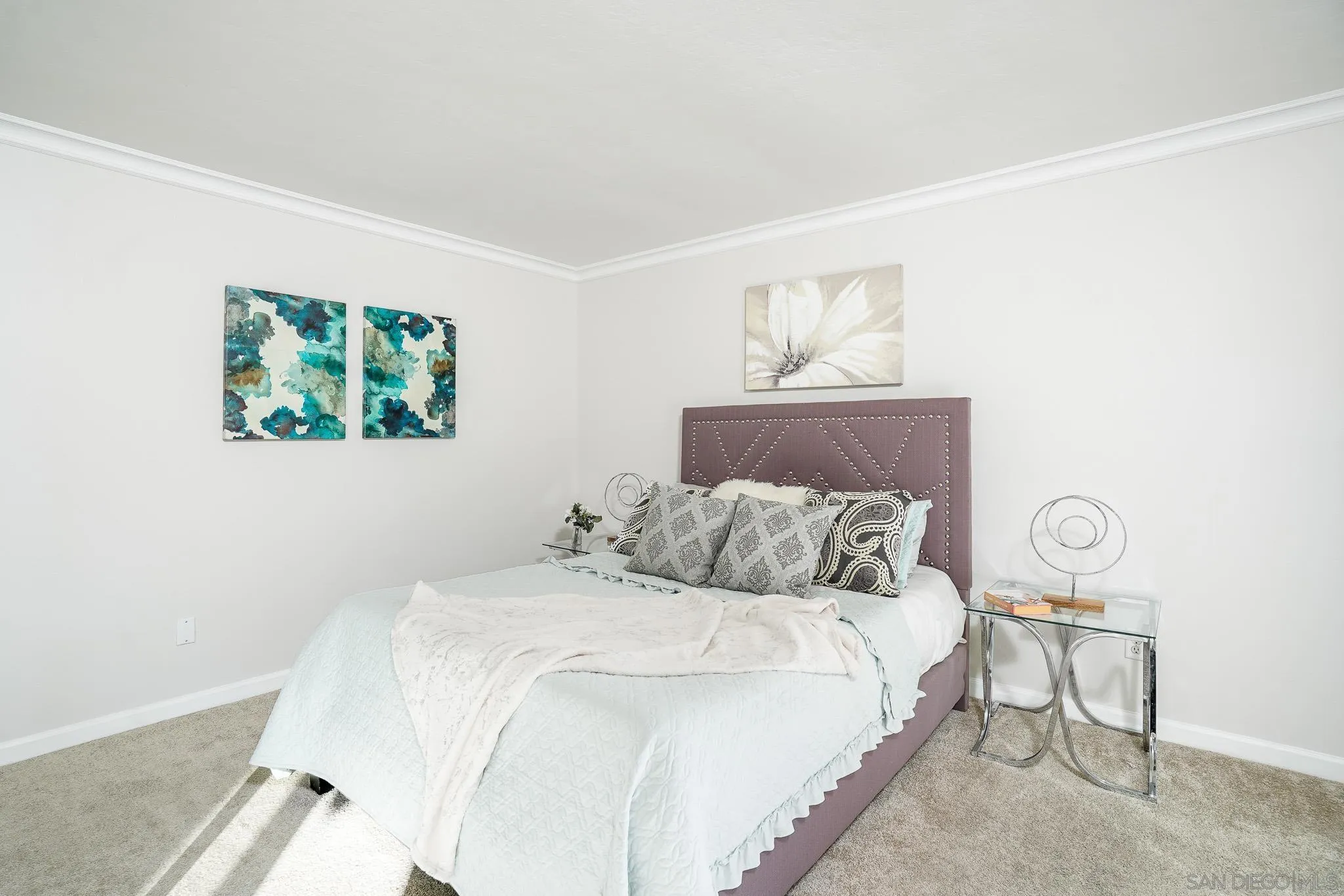 6069 Rancho Mission Road, Unit 201 San Diego, CA 92108 - Photo 24 of 43 a bedroom with a bed and a painting on the wall