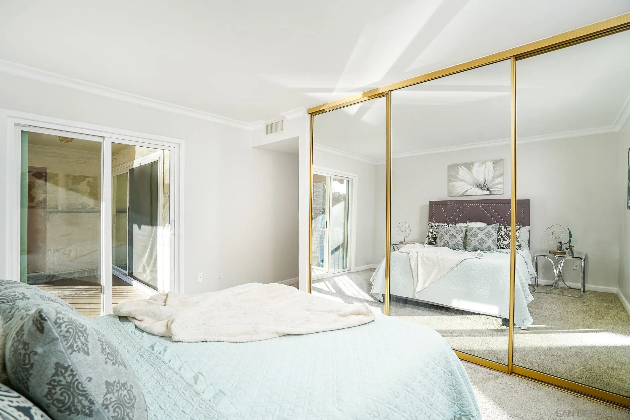 6069 Rancho Mission Road, Unit 201 San Diego, CA 92108 - Photo 26 of 43 a bedroom with a large bed and a large mirror