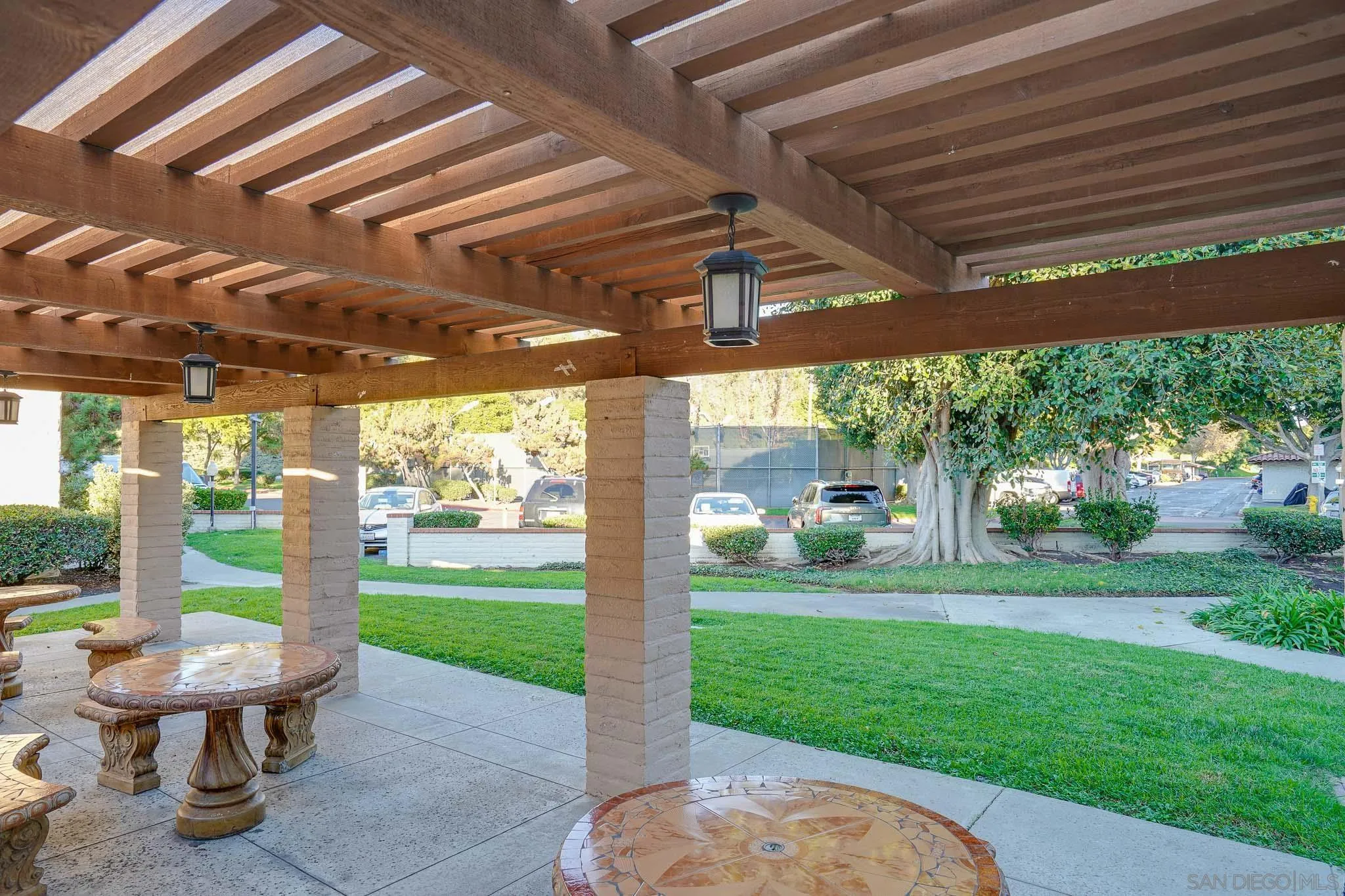 6069 Rancho Mission Road, Unit 201 San Diego, CA 92108 - Photo 31 of 43 a view of a porch with furniture and garden