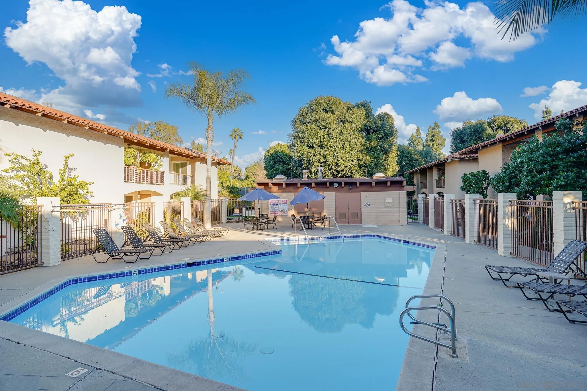 6069 Rancho Mission Road, Unit 201 San Diego, CA 92108 - Photo 34 of 43 a view of a swimming pool with outdoor seating