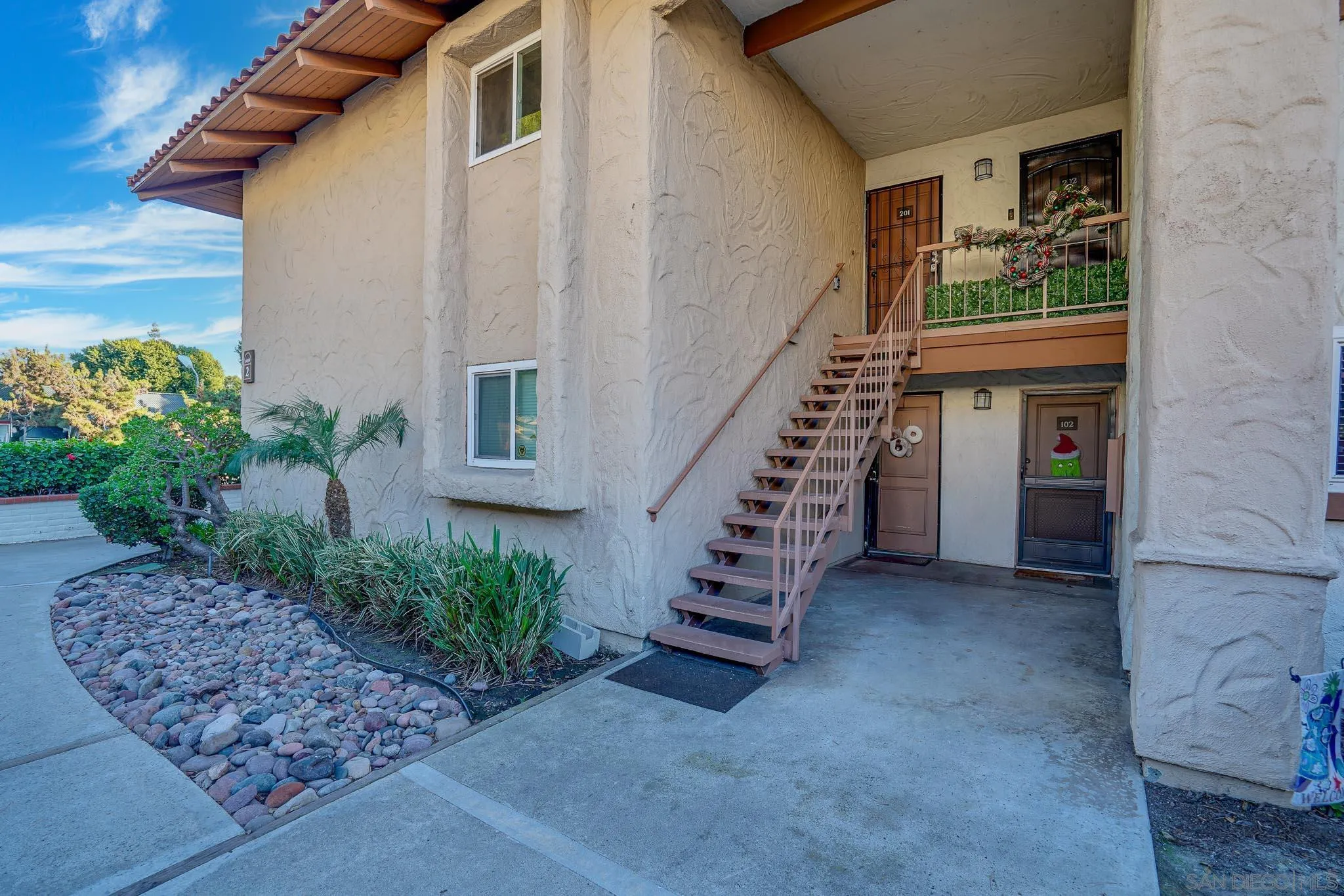6069 Rancho Mission Road, Unit 201 San Diego, CA 92108 - Photo 35 of 43 a view of entryway with a front door and wooden floor