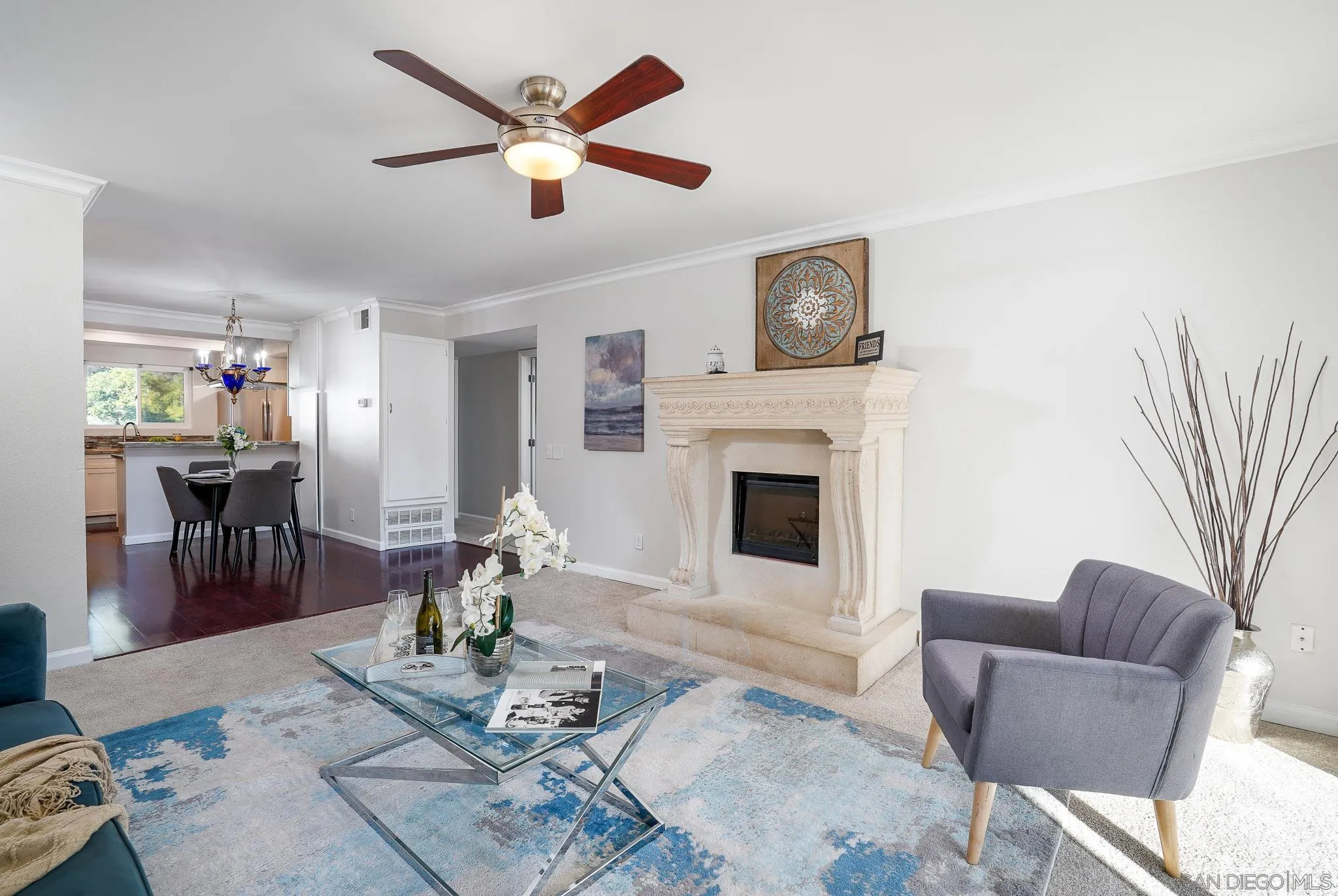 6069 Rancho Mission Road, Unit 201 San Diego, CA 92108 - Photo 8 of 43 a living room with furniture a fireplace and a chandelier