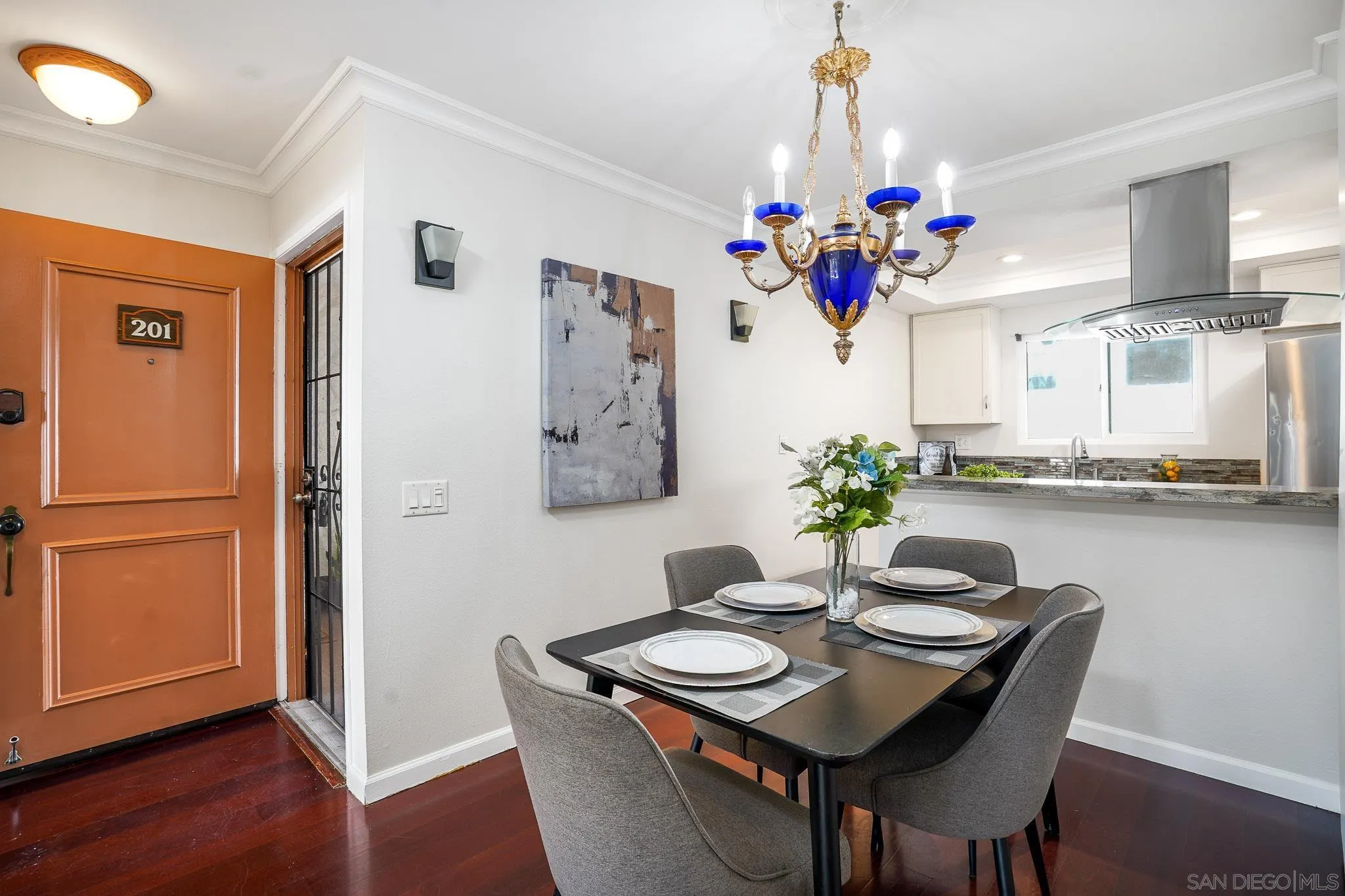 6069 Rancho Mission Road, Unit 201 San Diego, CA 92108 - Photo 9 of 43 a view of a dining room with furniture wooden floor and chandelier