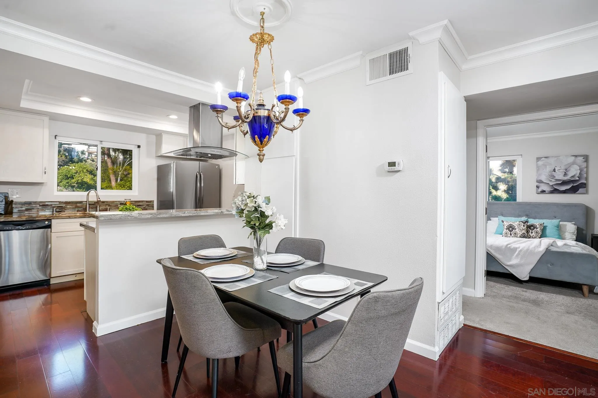 6069 Rancho Mission Road, Unit 201 San Diego, CA 92108 - Photo 10 of 43 a view of a dining room with furniture and wooden floor