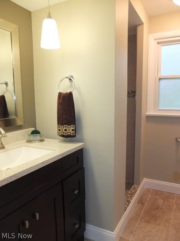 4262 Springdale Road Uniontown, OH 44685 - Photo 14 of 20 Additional full bath on the lower level with new vanity, solid surface countertop, tile flooring and shower surround.