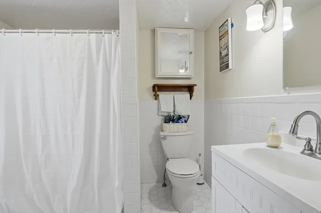 a white toilet sitting next to a bathroom sink