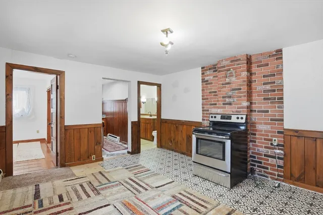 a view of kitchen with stove and refrigerator