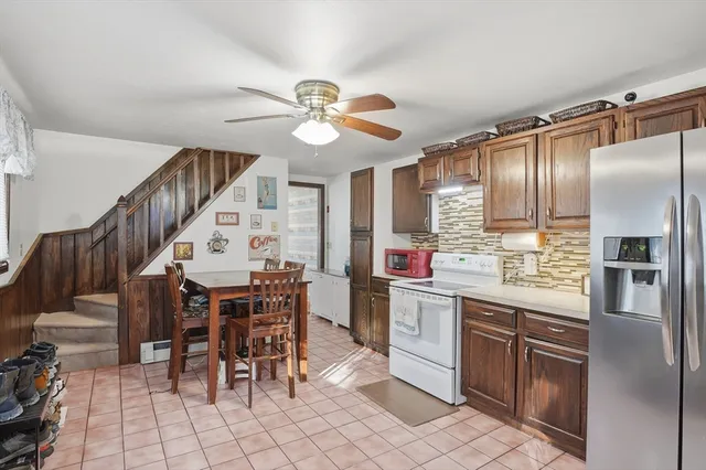 a kitchen with stainless steel appliances granite countertop a refrigerator and a sink