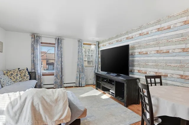 a bedroom with furniture and flat screen tv