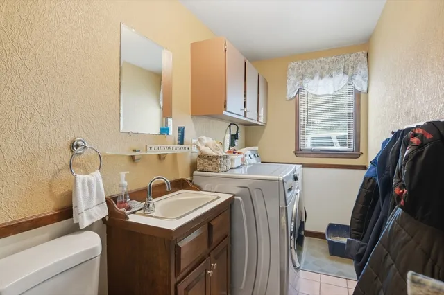 a utility room with sink dryer and washer