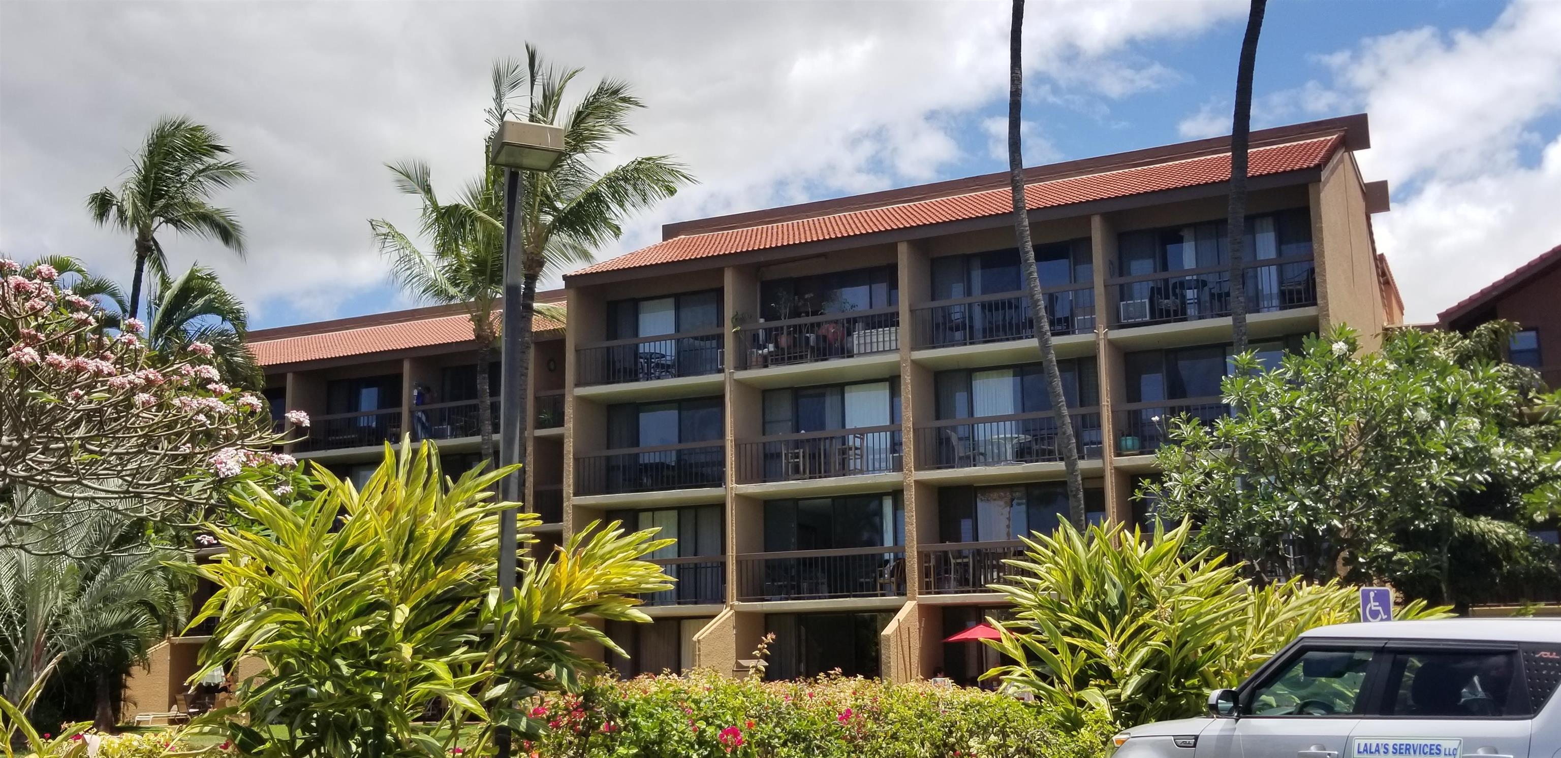 2191 South Kihei Road, Unit 2317 Kihei, HI 96753 - Photo 1 of 30 a front view of a house with a yard and potted plants