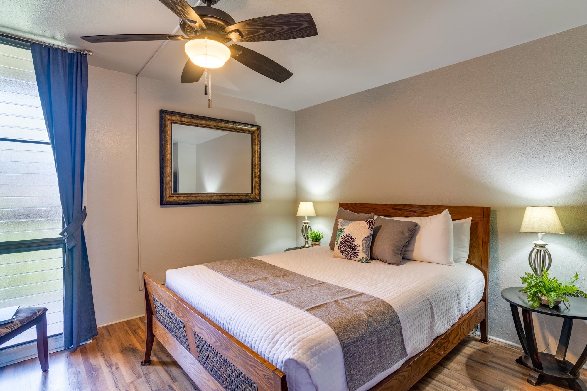 2191 South Kihei Road, Unit 2317 Kihei, HI 96753 - Photo 14 of 30 a bedroom with a bed and a chandelier