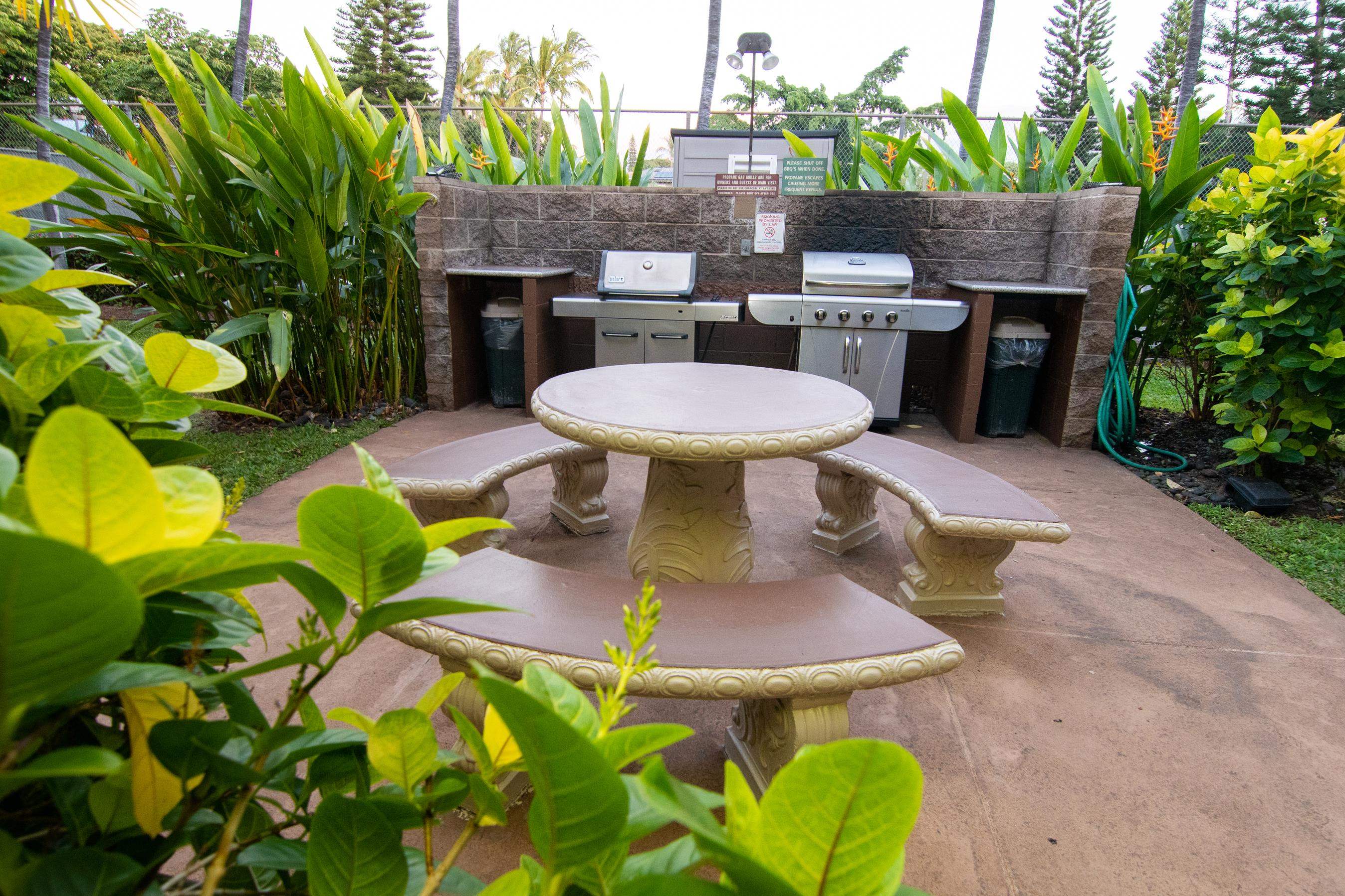 2191 South Kihei Road, Unit 2317 Kihei, HI 96753 - Photo 21 of 30 a view of a patio with table and chairs potted plants and a palm tree